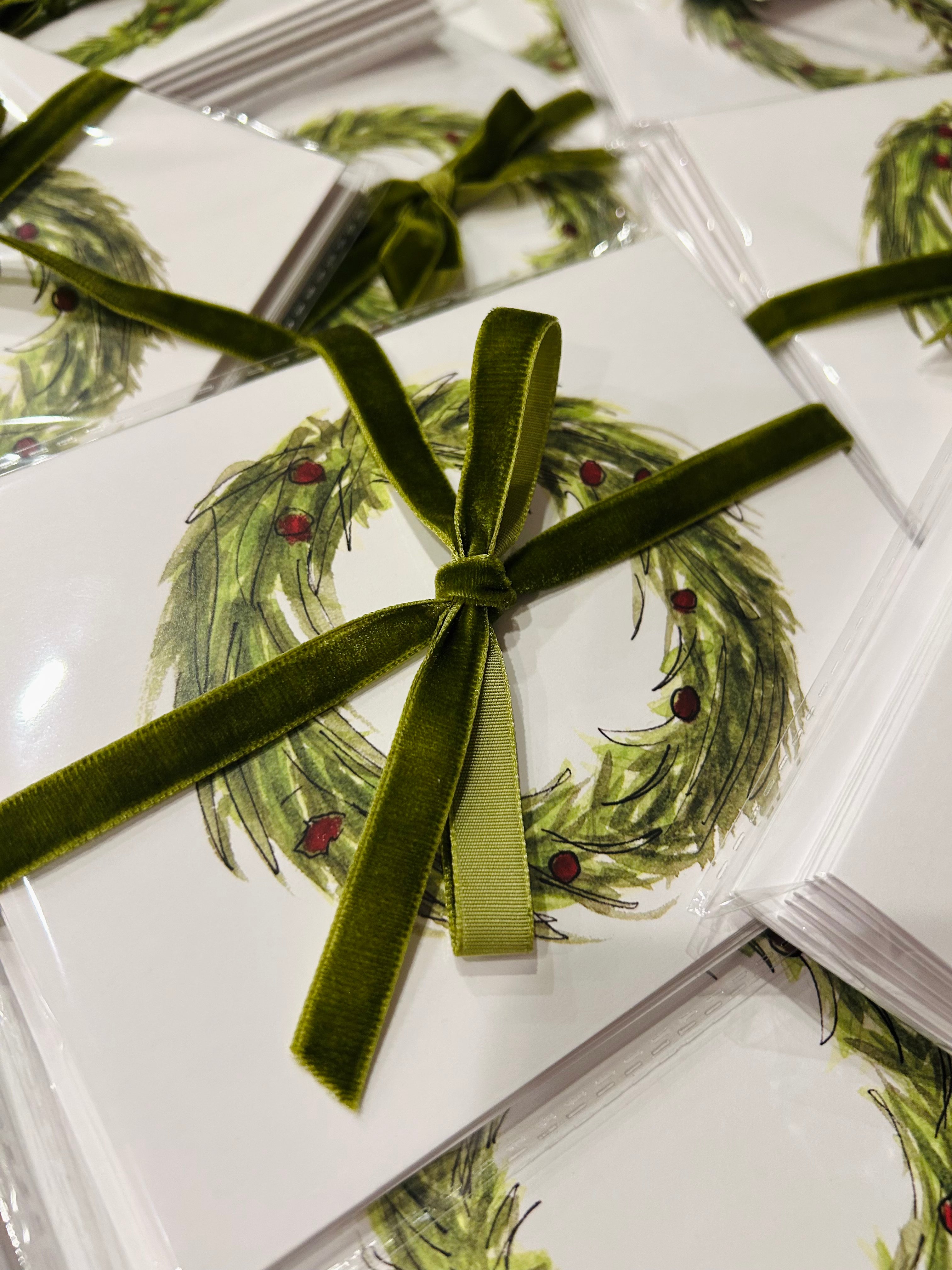 Packaged greeting cards with a wreath design and green ribbon 